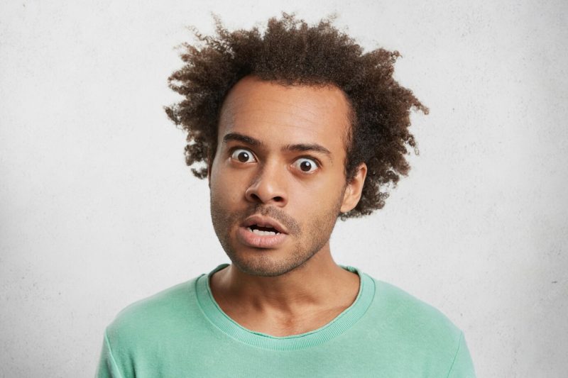 Indoor portrait of grumpy irritated annoyed man look furiously at camera, being angry Free Photo