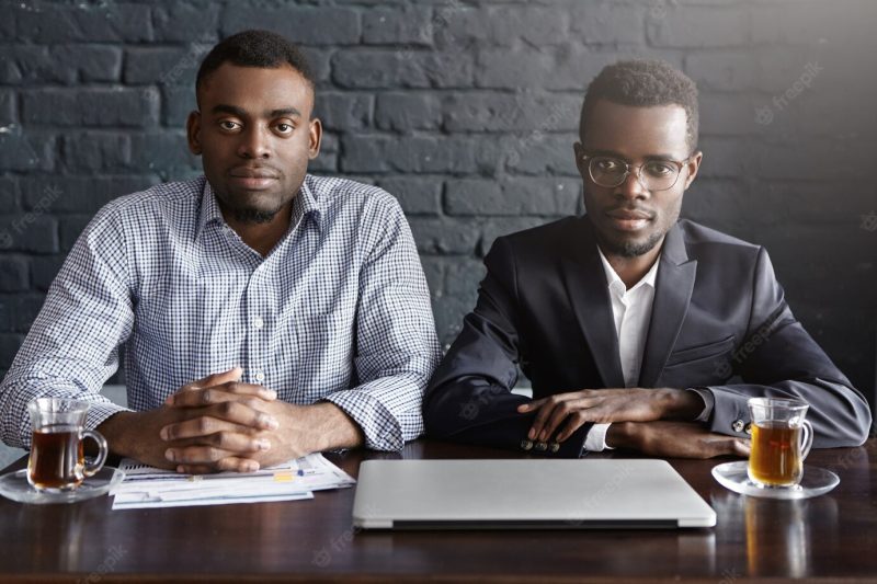 Indoor shot of two successful businessmen having meeting in modern office interior Free Photo