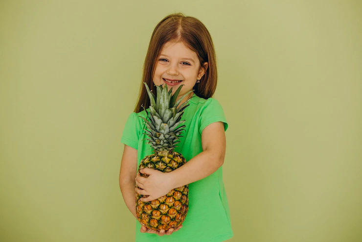 Little Girl Isolated Holding Pineapple 1303 31367
