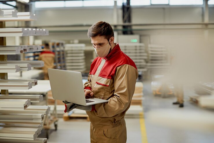 Male Carpenter With Face Mask Using Laptop While Checking Stock Workshop 637285 11783