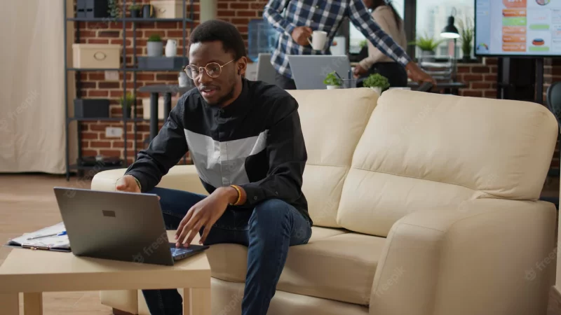 Male entrepreneur waving at videocall meeting webcam on laptop, using remote telecommunication on online videoconference. project manager talking to people on teleconference call. Free Photo