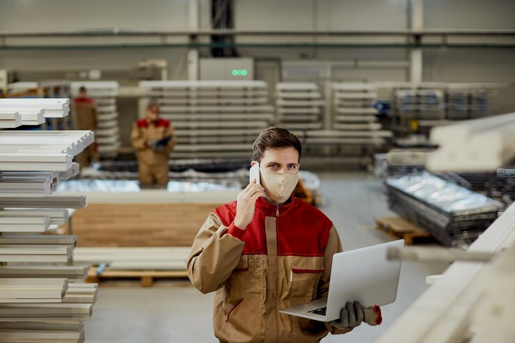 Male Worker Using Laptop While Talking Phone Carpentry Workshop 637285 11789