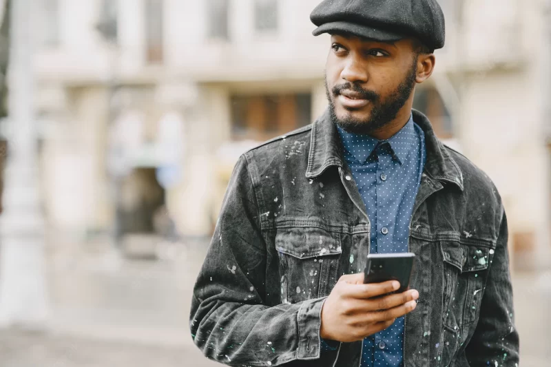 Man in the street. business concept. guy with mobile phone. Free Photo