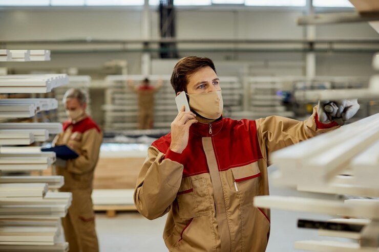 Manual Worker With Face Mask Talking Cell Phone While Working Carpentry Workshop 637285 11791