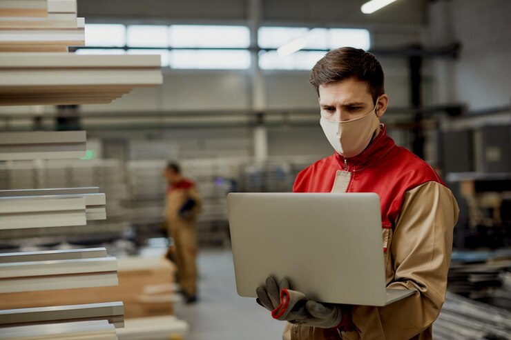 Manual Worker Working Laptop Carpentry Warehouse During Coronavirus Pandemic 637285 11785