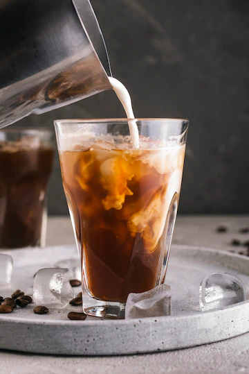 Milk Pouring Into Glass With Coffee 23 2148349600