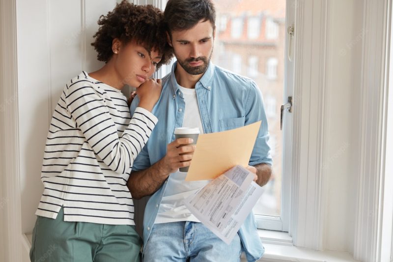 Mixed race family couple study budget together Free Photo