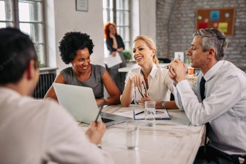 Multiethnic group of happy business people having a meeting in modern office Free Photo