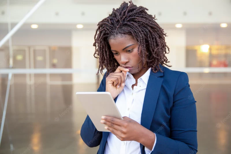 Pensive professional reading on screen outside Free Photo