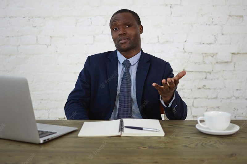 People, business, human facial expressions and reaction concept. indoor shot of handsome dark skinned male entrepreneur wearing formal suit having frustrated puzzled look, gesturing indignantly Free Photo