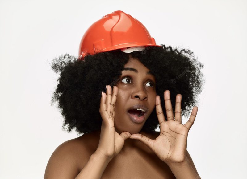 Portrait of confident female worker in orange helmet Free Photo