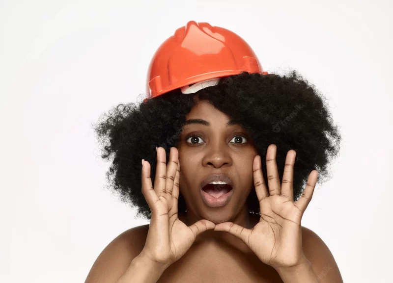 Portrait of confident female worker in orange helmet Free Photo