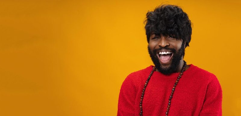 Portrait of smiling young black man in studio Free Photo