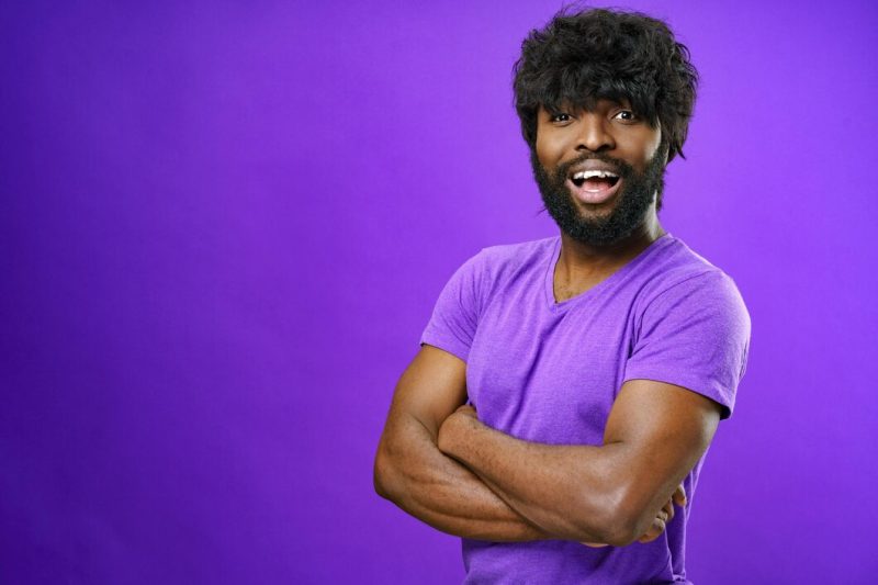 Portrait of smiling young black man in studio Free Photo