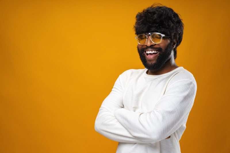 Portrait of smiling young black man in studio Free Photo