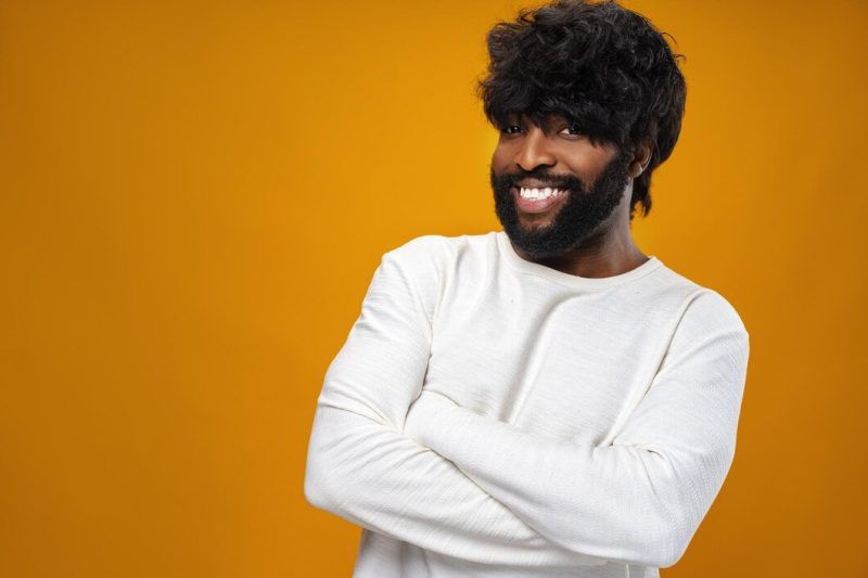 Portrait of smiling young black man in studio Free Photo