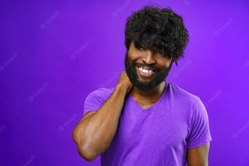 Portrait of smiling young black man in studio Free Photo