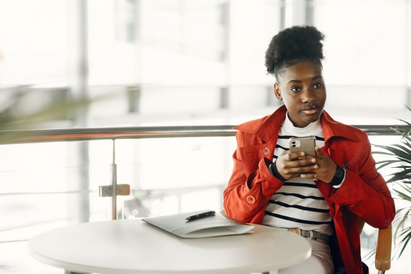 Portrait of smiling young businesswoman sitting in office Free Photo