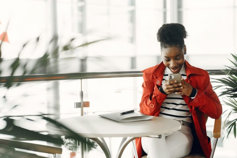 Portrait of smiling young businesswoman sitting in office Free Photo