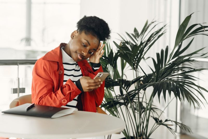 Portrait of smiling young businesswoman sitting in office Free Photo