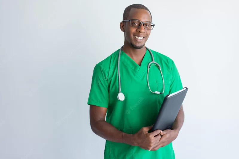 Portrait of successful young doctor with folder and stethoscope. Free Photo