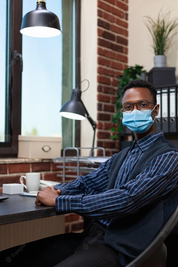 Portrait Successfull Startup Employee With Covid Face Mask Sitting Desk Looking Camera African American Entrepreneur With Glasses Posing Confident Sitting Bussiness Office 482257 36918