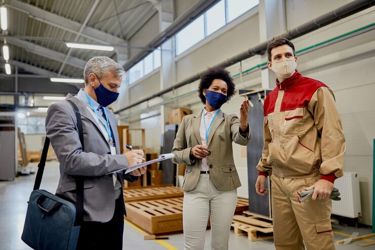 Quality Control Inspectors Talking Male Worker While Visiting Woodworking Factory During Coronavirus Pandemic 637285 11857