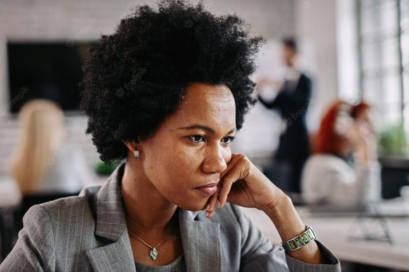 Serious African American businesswoman thinking of something while being in the office Free Photo