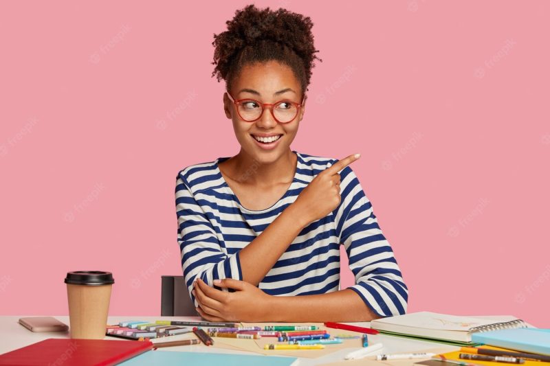 Shot of pleased smiling African painter dressed in striped sailor clothes Free Photo