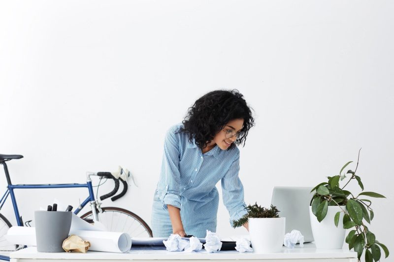 Smiling African American young woman engineer using laptop at office Free Photo