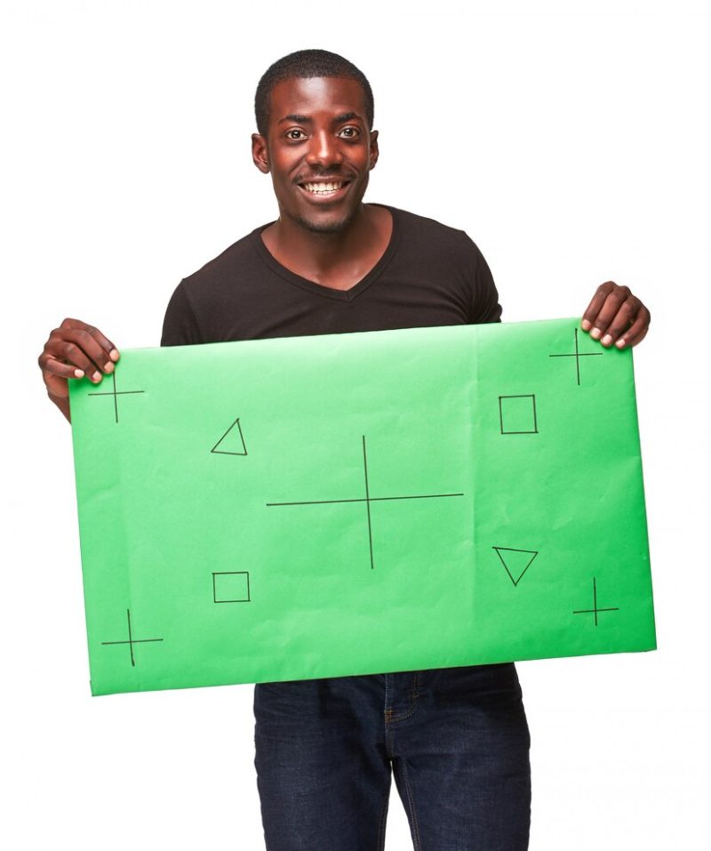 Smiling African man as black businessman with green panel Free Photo