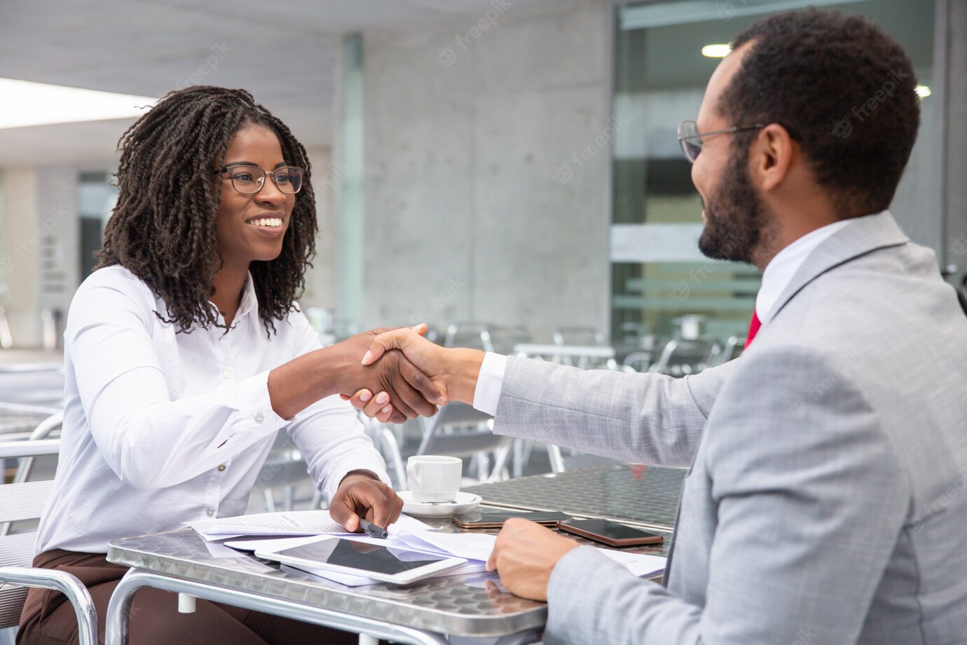 Smiling Businesswoman Shaking Hands With Partner 74855 3124