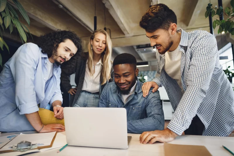 Smiling multiracial coworkers working together at office meeting have a discussion Free Photo