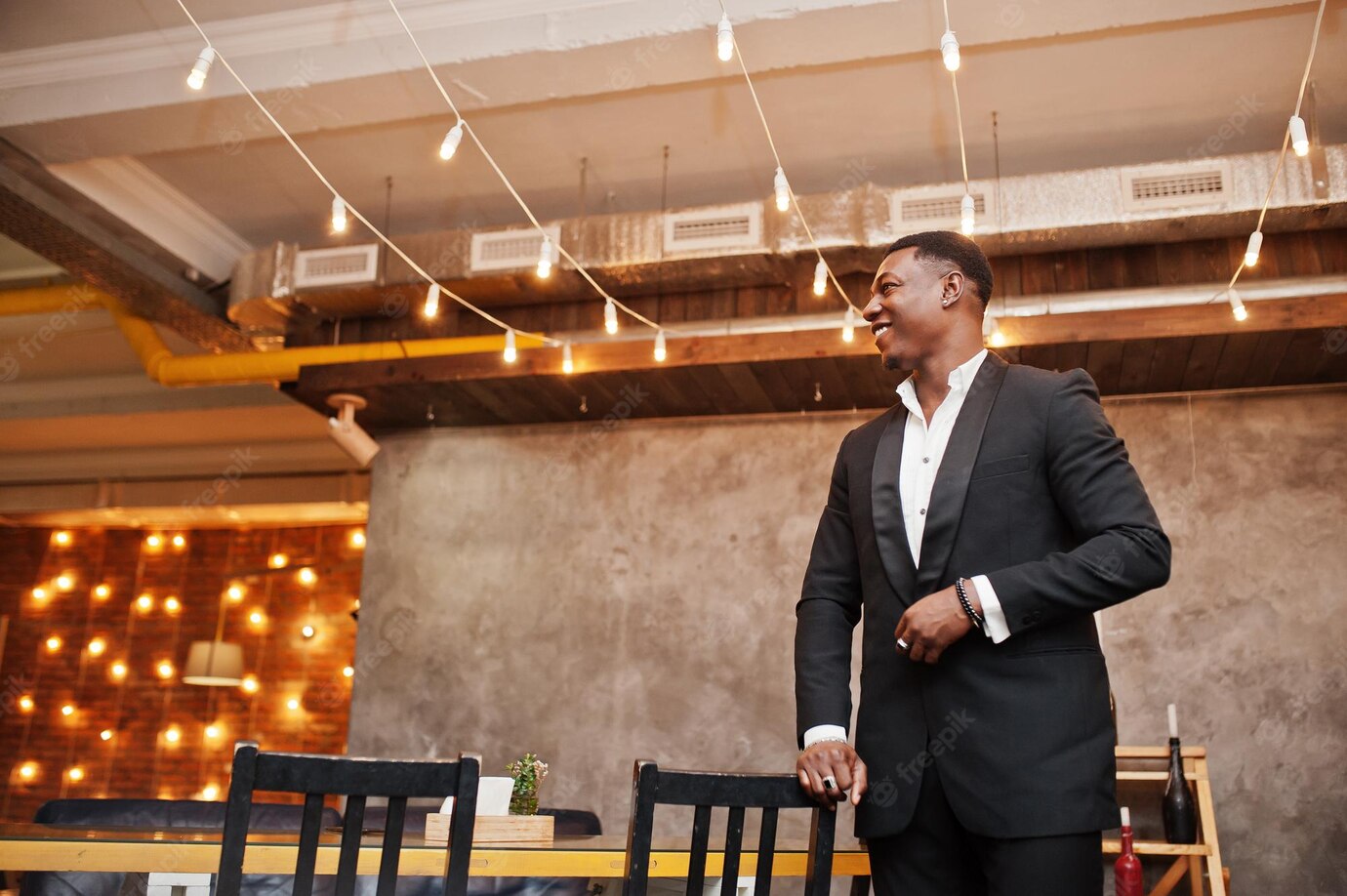 Strong Powerful African American Man In Black Suit Posed In Cafe Free Photo