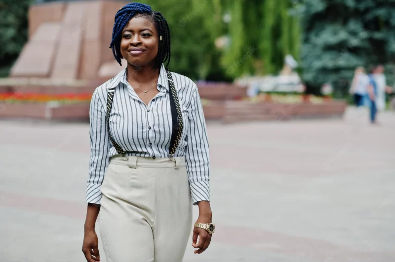 Stylish african american business woman at trousers with suspender and blouse posed outdoor Free Photo