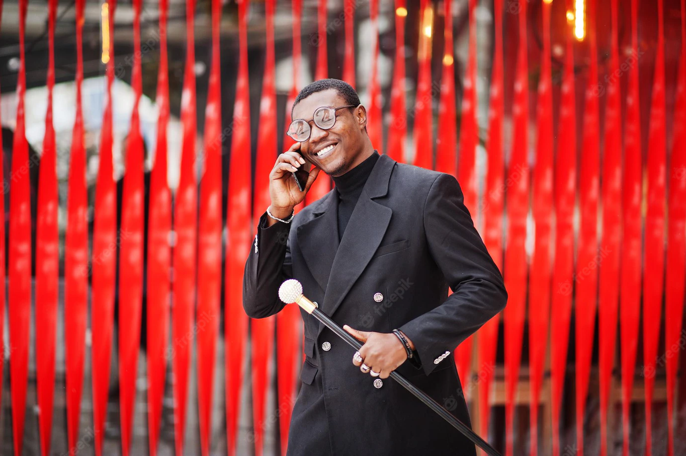 Stylish African American Gentleman Elegant Black Jacket Holding Retro Walking Stick As Cane Flask Tippling Cane Rich Fashionable Afro Man Against Red Wall Speaking Mobile Phone 627829 1432