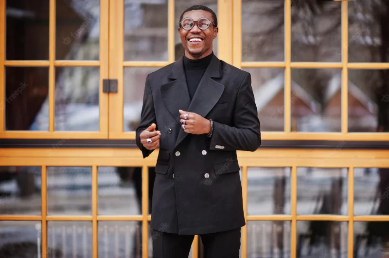 Stylish african american gentleman in elegant black jacket rich fashionable Afro man against window Free Photo