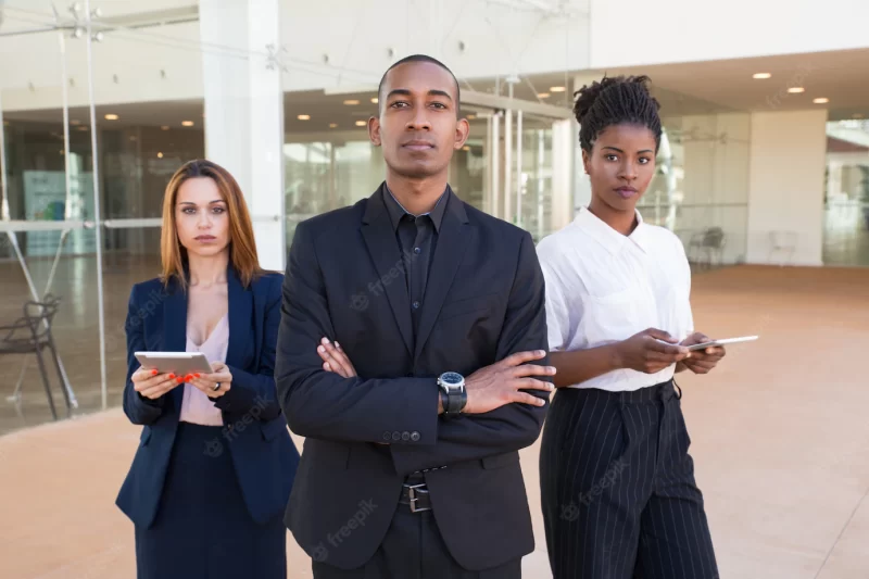 Successful business team posing in office hall Free Photo