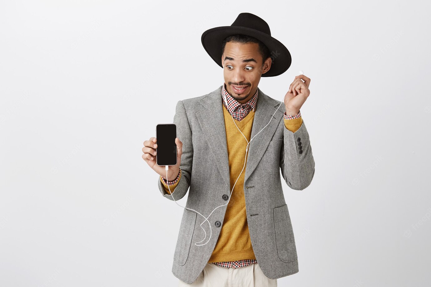 Surprised African American Guy Take Off Headphone Ambushed Awkward Looking Smartphone Screen Showing Mobile Display 176420 25173