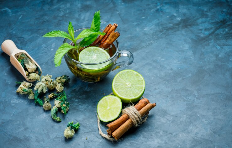 Tea Cup With Mint Cinnamon Dried Herbs Lime Grungy Blue Surface High Angle View 176474 6738