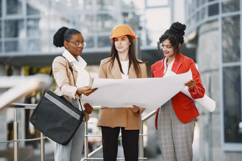 Three women working as architectors on a constraction and making a decision about plan of a building Free Photo Three women working as architectors on a constraction and making a decision about plan of a building Free Photo