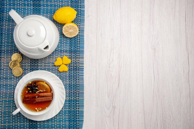 Top Close Up View Sweets Cup Tea Cup Herbal Tea With Lemon Cinnamon Lemon Teapot Different Sweets Checkered Tablecloth Left Side Table 140725 111484