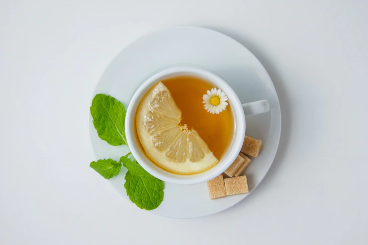 Top View Cup Chamomile Tea With Lemon Mint Leaves Sugar White Surface Horizontal 176474 5080