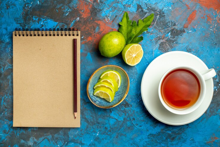 Top View Cup Tea With Slices Lemon Pencil Notebook Blue Red Surface 140725 62945