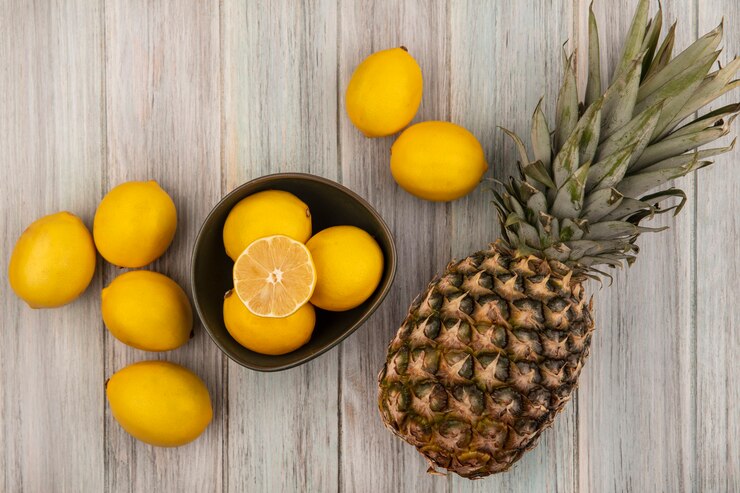 Top View Fresh Juicy Lemons Bowl With Pineapple Lemons Isolated Grey Wooden Surface 141793 81389