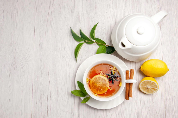 Top View Tea Cinnamon Cup Herbal Tea Cinnamon Sticks Saucer Lemon Teapot Leaves White Table 140725 111764