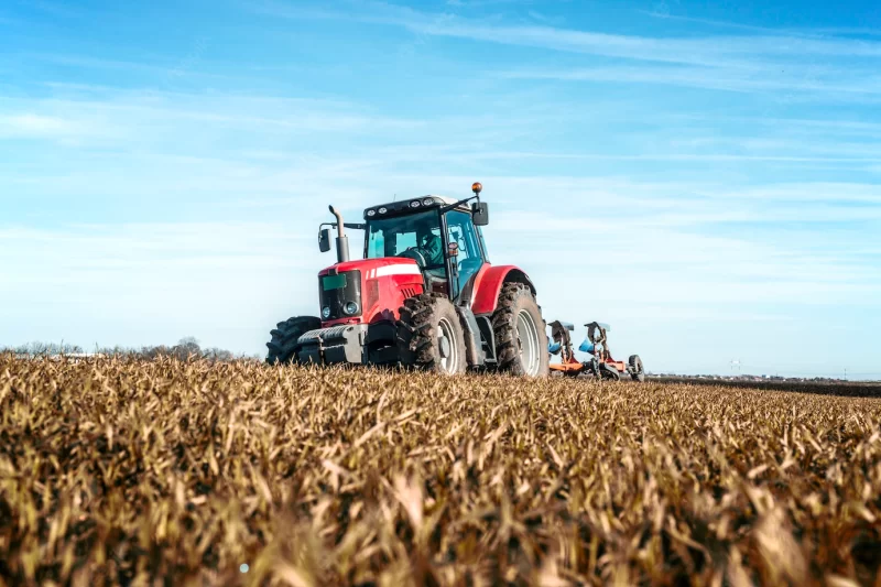 Tractor agricultural machine cultivating field Free Photo