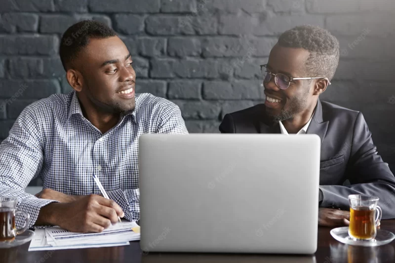 Two successful and experienced African-American executives smiling happily Free Photo