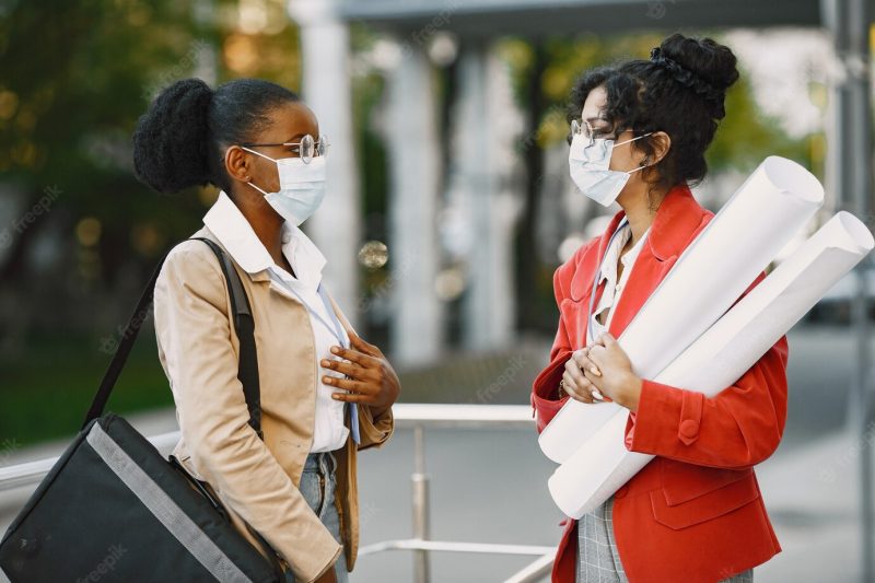 Two women working as architectors on a constraction. people making a decision about plan of a building. quarantine concept Free Photo