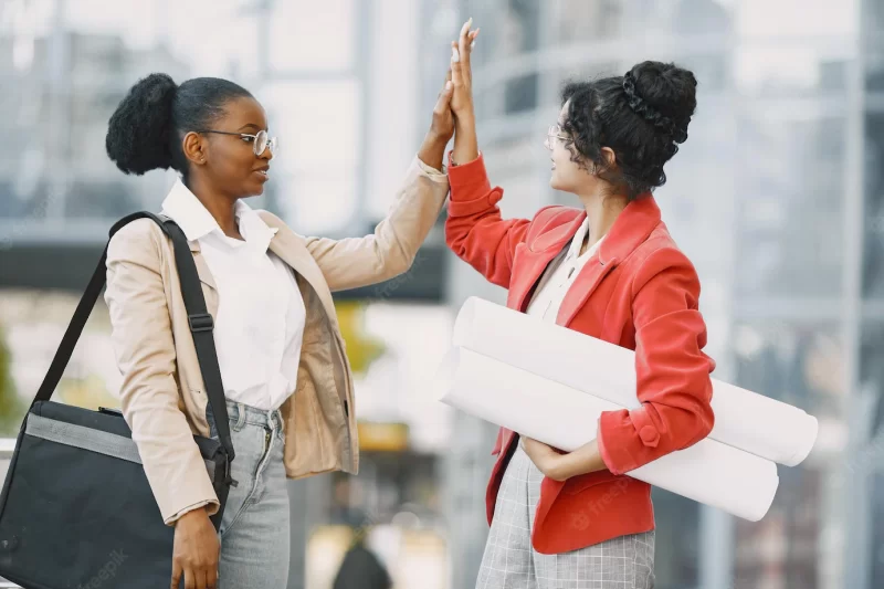 Two women working as architectors. people on a constraction and making a decision about plan of a building. Free Photo